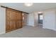 Bonus room with dark wood sliding door, carpet and a window letting in natural light at 71 Del Corso Ct, Clayton, NC 27527
