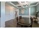 Elegant dining room with coffered ceiling, wainscoting, and a designer chandelier at 71 Del Corso Ct, Clayton, NC 27527