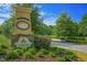 Community entrance sign with beautiful landscaping and stone accents at 71 Del Corso Ct, Clayton, NC 27527