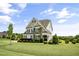 Lovely two-story home with stone accents, shutters, and a lush green lawn at 71 Del Corso Ct, Clayton, NC 27527