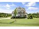 Beautiful two-story home featuring a stone facade and a well-manicured front lawn at 71 Del Corso Ct, Clayton, NC 27527