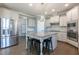 This kitchen features a large center island with granite countertops, stainless steel appliances, and white cabinetry at 71 Del Corso Ct, Clayton, NC 27527