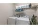 Functional laundry area features a washer, a dryer, shelving for storage, and neutral walls at 71 Del Corso Ct, Clayton, NC 27527