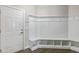 Bright mudroom with white wainscoting, bench seating, and convenient storage cubbies by the entrance at 71 Del Corso Ct, Clayton, NC 27527