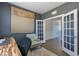 Home office features a textured accent wall, a chair and hardwood flooring. A doorway leads into another room at 71 Del Corso Ct, Clayton, NC 27527