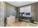 Office features a large window, neutral carpet, dark gray walls, and a desk with computer monitors at 71 Del Corso Ct, Clayton, NC 27527
