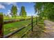 Wooden fence showing the property line with green fields on a sunny day at 71 Del Corso Ct, Clayton, NC 27527