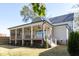 Spacious backyard and covered porch complete with ceiling fans, perfect for outdoor living and entertaining at 717 Penn Rd, Raleigh, NC 27604