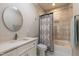 Stylish bathroom with a modern vanity, round mirror, and tiled shower/tub combo at 717 Penn Rd, Raleigh, NC 27604