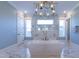 Spa bathroom featuring a luxury soaking tub under an elegant chandelier at 717 Penn Rd, Raleigh, NC 27604