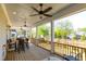 Spacious covered deck featuring ceiling fans, recessed lighting, and outdoor dining area with views of the backyard at 717 Penn Rd, Raleigh, NC 27604