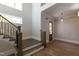 Elegant foyer featuring hardwood floors, stairs with iron railings, and a decorative front door at 717 Penn Rd, Raleigh, NC 27604