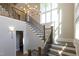 Grand foyer featuring hardwood floors, chandelier, staircase with iron railings and natural light at 717 Penn Rd, Raleigh, NC 27604
