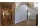 Bright hallway with hardwood floors, elegant lighting fixtures, and access to various rooms at 717 Penn Rd, Raleigh, NC 27604