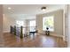 Upstairs landing area with hardwood floors, black metal railing, and large windows at 717 Penn Rd, Raleigh, NC 27604