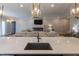 Open-concept kitchen with island seating overlooking the cozy living area with a fireplace at 717 Penn Rd, Raleigh, NC 27604