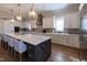 Eat-in kitchen with granite countertops, stainless steel appliances, island seating, and custom cabinetry at 717 Penn Rd, Raleigh, NC 27604