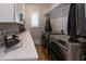 Laundry room with modern washer/dryer, quartz countertops, and ample cabinet space at 717 Penn Rd, Raleigh, NC 27604