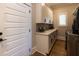 Well-lit laundry room featuring custom cabinets, countertops, and modern appliances at 717 Penn Rd, Raleigh, NC 27604