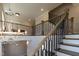 Elegant staircase with wooden handrails and a decorative chandelier at 717 Penn Rd, Raleigh, NC 27604