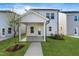Exterior backyard view featuring a covered patio with a ceiling fan, landscaping, and walkway at 761 Portland Rose Dr, Knightdale, NC 27545