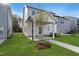 Exterior backyard view featuring a covered patio with a ceiling fan, landscaping, and a walkway at 761 Portland Rose Dr, Knightdale, NC 27545