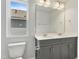 Modern bathroom with gray double sink vanity, mirror, toilet, and large window at 761 Portland Rose Dr, Knightdale, NC 27545