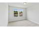 Bright, carpeted bedroom with two windows providing plenty of natural light at 761 Portland Rose Dr, Knightdale, NC 27545