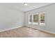 Bright, empty bedroom featuring hardwood floors and multiple windows at 761 Portland Rose Dr, Knightdale, NC 27545