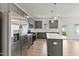 Modern kitchen with stainless steel appliances, quartz countertops, and grey cabinetry at 761 Portland Rose Dr, Knightdale, NC 27545