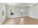 Bright living room with hardwood floors, neutral walls, natural light, and white trim at 761 Portland Rose Dr, Knightdale, NC 27545