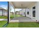 This home features a covered patio with a ceiling fan and brick trim overlooking the spacious backyard at 761 Portland Rose Dr, Knightdale, NC 27545