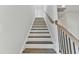 Bright staircase features wood railings and trim with white risers at 761 Portland Rose Dr, Knightdale, NC 27545