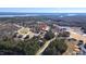 Aerial view of the community with a serene lake view and lush green trees at 78 Rolling Meadows Ln, Chapel Hill, NC 27517