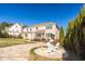 Paver patio with a fire pit and adirondack chairs in a spacious backyard with landscaping at 78 Rolling Meadows Ln, Chapel Hill, NC 27517