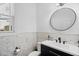 Stylish powder room features tiled walls, modern vanity, and a round mirror at 78 Rolling Meadows Ln, Chapel Hill, NC 27517