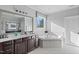 Elegant bathroom features dark wood cabinetry and separate tub at 78 Rolling Meadows Ln, Chapel Hill, NC 27517