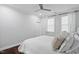Bright bedroom with white walls, dark wood floor, and a modern ceiling fan at 78 Rolling Meadows Ln, Chapel Hill, NC 27517