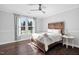 Comfortable bedroom features a ceiling fan and hardwood floors at 78 Rolling Meadows Ln, Chapel Hill, NC 27517