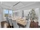 Open dining room concept with a view of the staircase and a Christmas tree, featuring modern decorations at 78 Rolling Meadows Ln, Chapel Hill, NC 27517