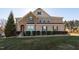 Charming two-story home with brick and stone exterior, manicured lawn, and professional landscaping at 78 Rolling Meadows Ln, Chapel Hill, NC 27517