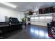View of the organized garage with storage racks and a black truck and motorcycle inside at 78 Rolling Meadows Ln, Chapel Hill, NC 27517