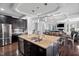 Bright kitchen features a large island, dark cabinets and is connected to dining and living areas at 78 Rolling Meadows Ln, Chapel Hill, NC 27517