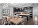 A modern kitchen and dining area with dark cabinets, a large island, and a beautifully set wooden table at 78 Rolling Meadows Ln, Chapel Hill, NC 27517