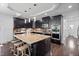 Modern kitchen features a large island with seating, dark cabinets, and stainless steel appliances at 78 Rolling Meadows Ln, Chapel Hill, NC 27517
