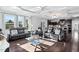 Inviting living space featuring leather seating, a modern glass table, and an open view to the kitchen at 78 Rolling Meadows Ln, Chapel Hill, NC 27517