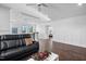 Bright living room with hardwood floors and leather couch at 78 Rolling Meadows Ln, Chapel Hill, NC 27517