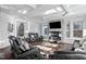 Bright living room features a stone fireplace, built-in shelving, coffered ceilings and modern furniture at 78 Rolling Meadows Ln, Chapel Hill, NC 27517