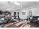 Spacious living room with leather furniture, hardwood floors, and a bright, airy atmosphere open to the kitchen at 78 Rolling Meadows Ln, Chapel Hill, NC 27517