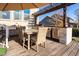 Outdoor dining area on wood deck, featuring pergola, grill and woven chairs at 78 Rolling Meadows Ln, Chapel Hill, NC 27517